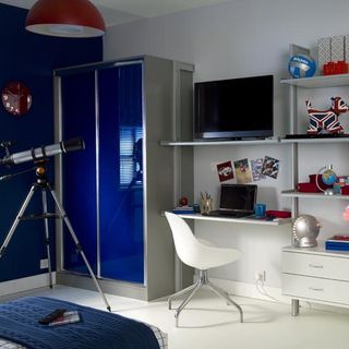 bedroom with sliding wardrobe doors and telescope