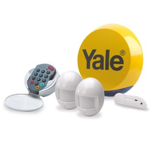 Yale HSA Essentials Alarm Kit with yellow burglar alarm and white accessories on white background