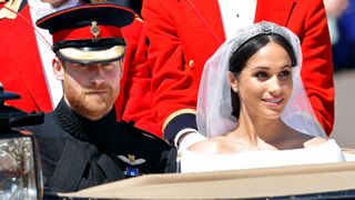 Prince Harry, Duke of Sussex and Meghan, Duchess of Sussex travel in an Ascot Landau carriage as they begin their procession through Windsor following their wedding