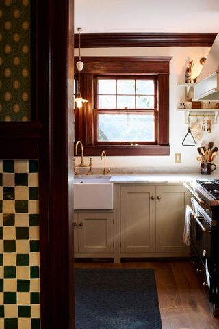 small beige kitchen with checkerboard tiled pantry