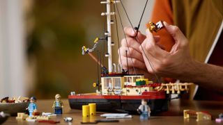 A closer look at the Lego Ideas "Jaws" set showing the assembled boat and assorted accessories