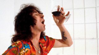 Bon Scott drinking a glass of wine
