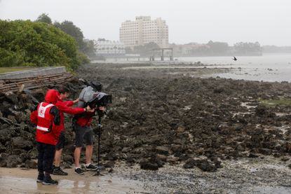 A news crew films Hurricane Irma.