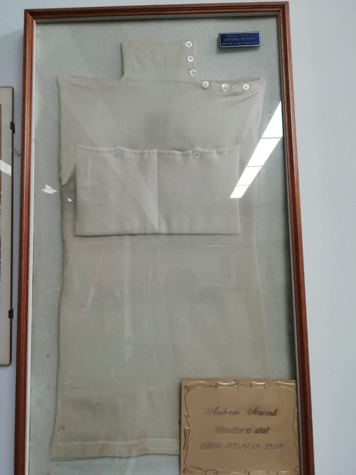 Antonio Pesenti's 1932 maglia rosa on display at the Pesenti bike shop in Bergamo