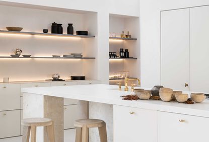 a kitchen with led lit shelves