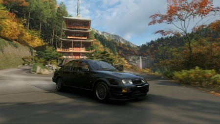 Forza Horizon 6 black Ford Cosworth drifting in front of the Japanese Temple of Nachi Falls with ther waterfall visible in the distance