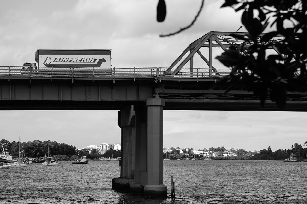 Traffic on a bridge in black and white