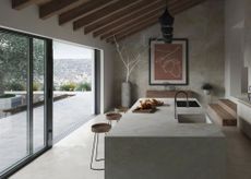 grey concrete kitchen with vaulted ceiling and sliding glass doors