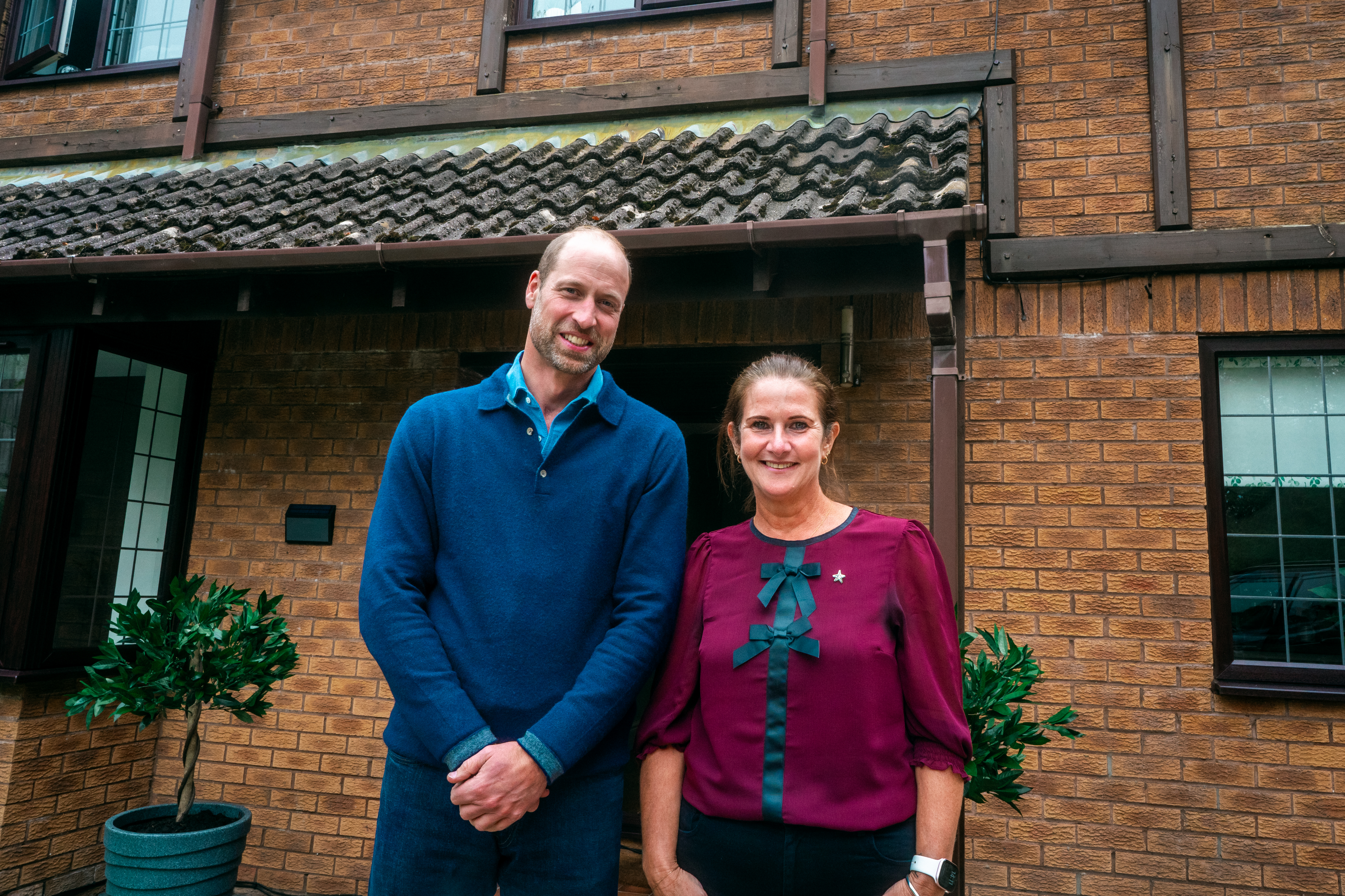 Prince William and Rhian Mannings standing outside her house