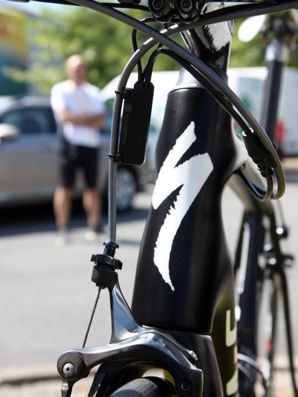 The extra-wide top tube and down tube give the head tube a distinctly curvy profile. Oh, and that ominous figure standing in the background? That's part of the team's security detail.