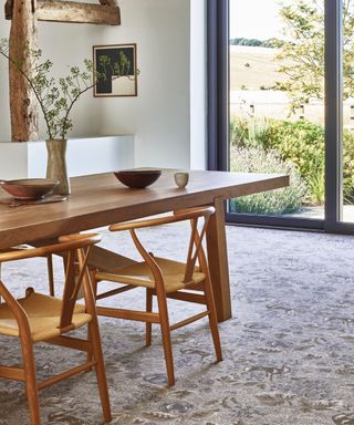 dining room with mid-century modern table and chairs, rug, critical doors to outside, Brintons