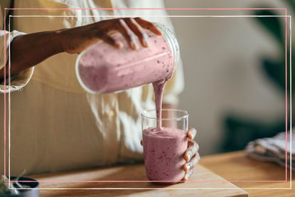 a woman on an extreme diet pouring a pink fruit smoothie into a glass