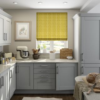 Orla Keily mustard roller blind in a grey kitchen