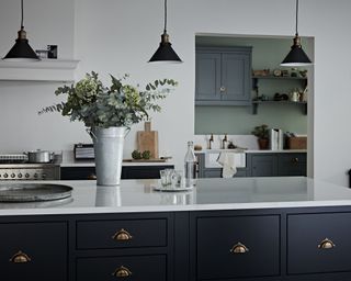 A kitchen lighting idea with Kitchen Makers Haddon in Charcoal and Burnished Bronze shaker style unit and black brass ceiling lights