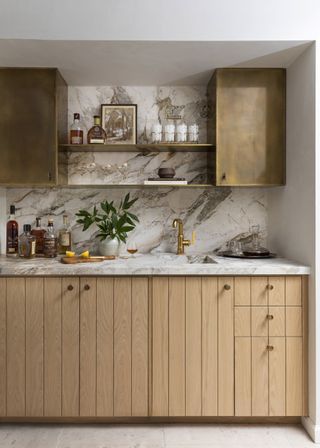 A kitchen with splashback running up the wall