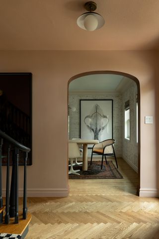 Blush pink hallway with view into dining room