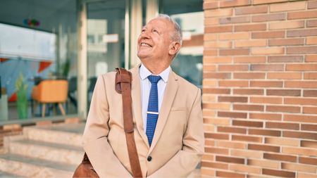 Senior grey-haired businessman smiling 