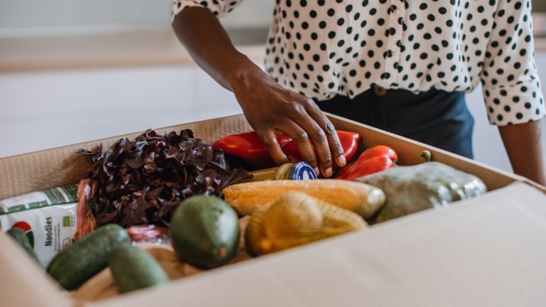 woman opening food subscription box