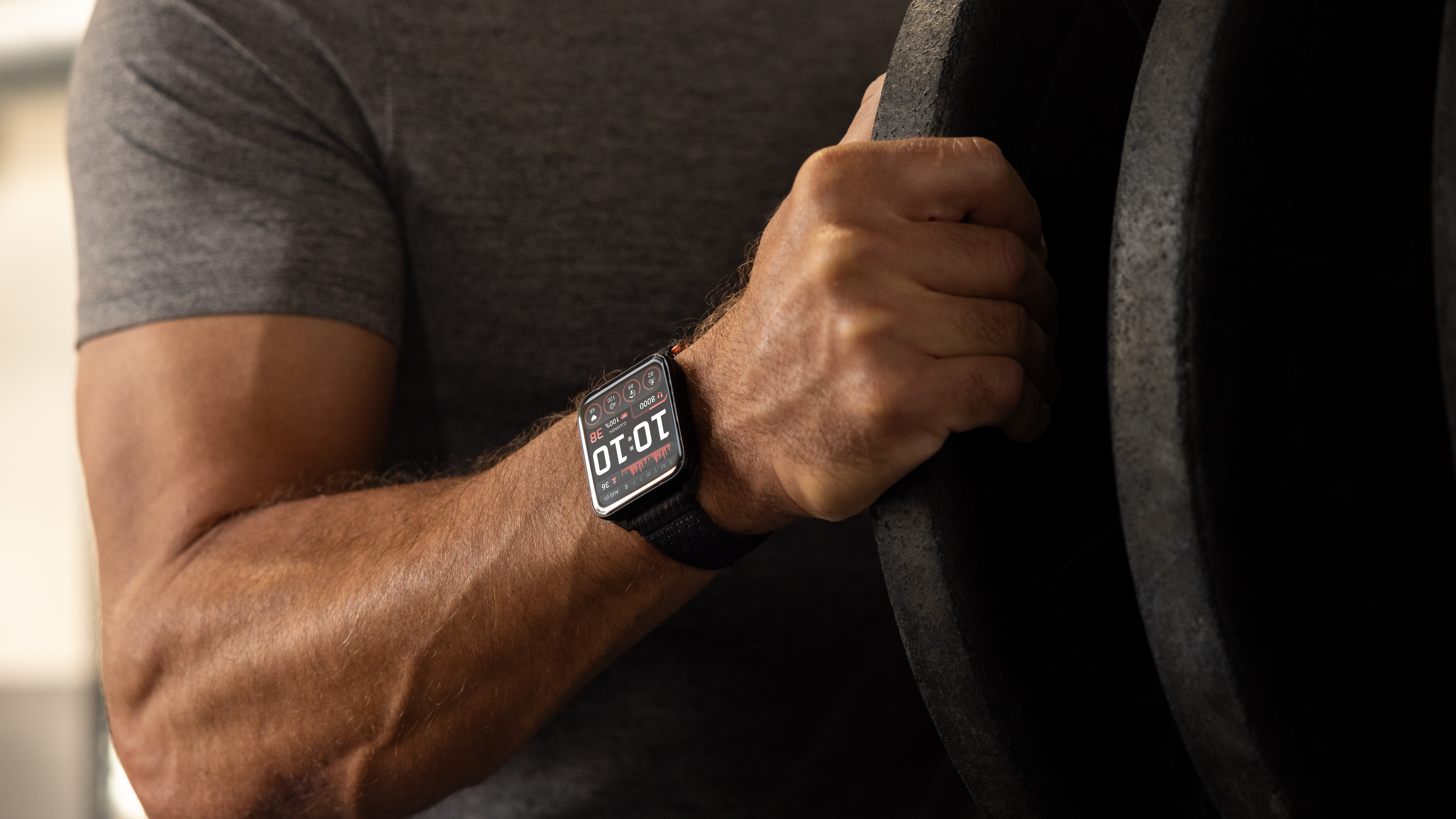 Photo of the Garmin Venu X1 on a weightlifter's wrist as they work out