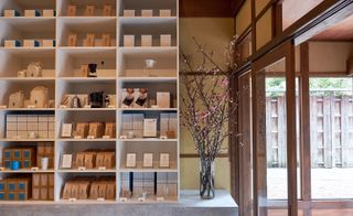 View of the coffee bar and wooden shelving at Blue Bottle Coffee in Kyoto