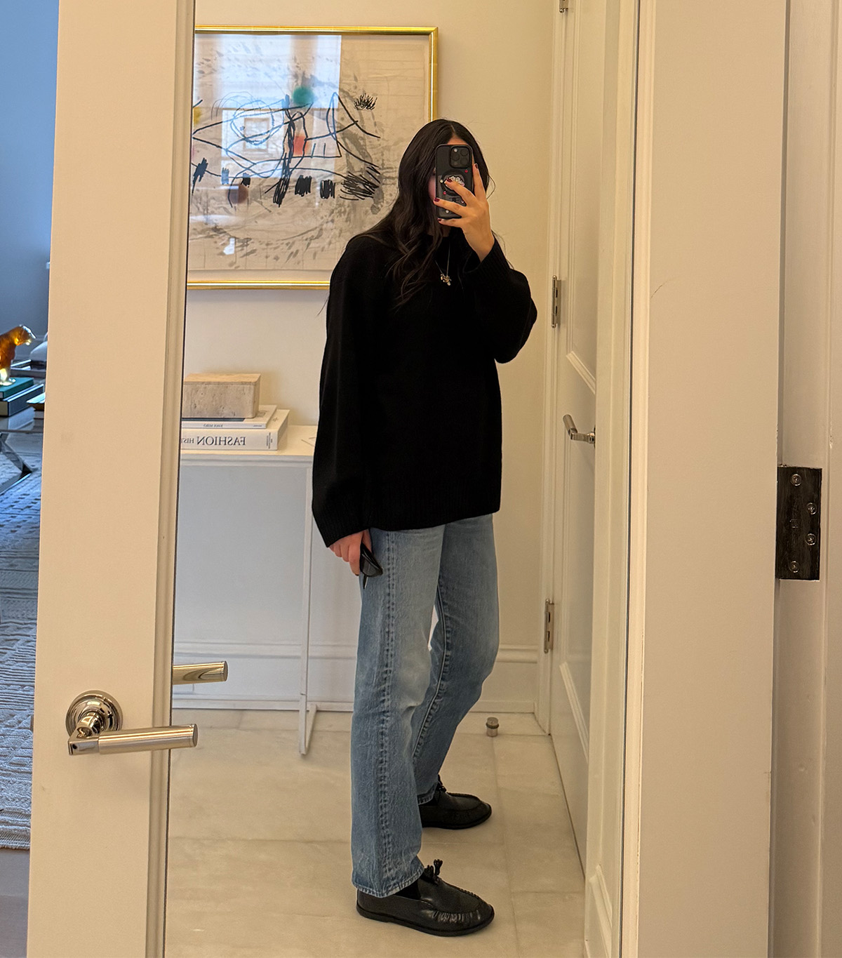 @nicoleakhtarzad taking a mirror selfie wearing a winter outfit.