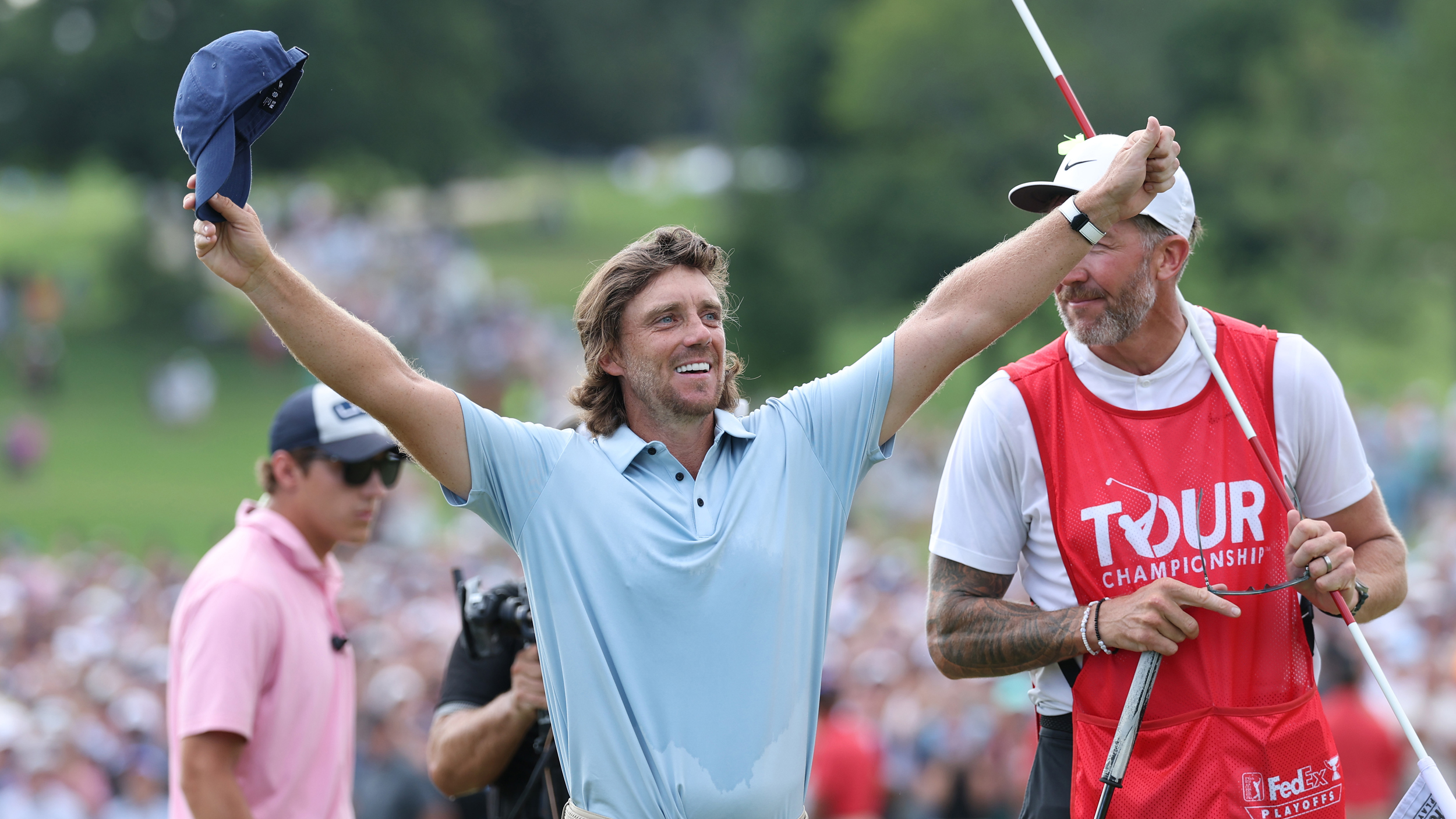 Tommy Fleetwood puts his arms outstretched in celebration after winning the 2025 FedEx Cup and the Tour Championship
