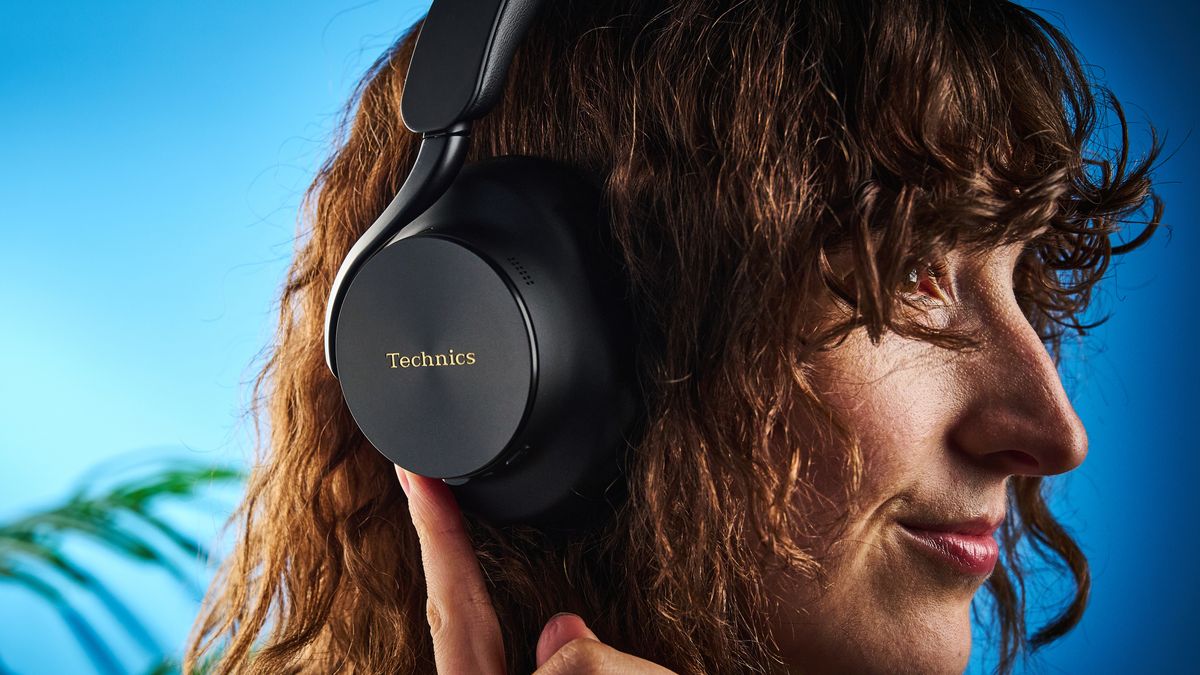 the technics eah-a1000 headphones with a gold technics logo photographed against a blue background