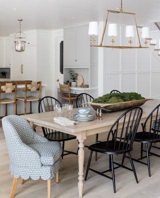 dining area with wooden table, blue hero chair and black chairs