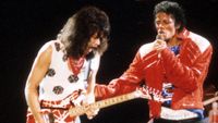 DALLAS - JULY 1984: Guitarist Eddie Van Halen joins pop star Michael Jackson on stage to perform his hit song "Beat It" during The Jacksons Victory Tour on July 14, 1984 at Texas Stadium in Dallas, Texas. (Photo by Michael Ochs Archives/Getty Images)