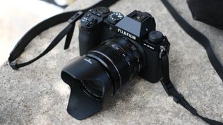 Fujifilm X-S20 digital camera with a lens on a concrete surface