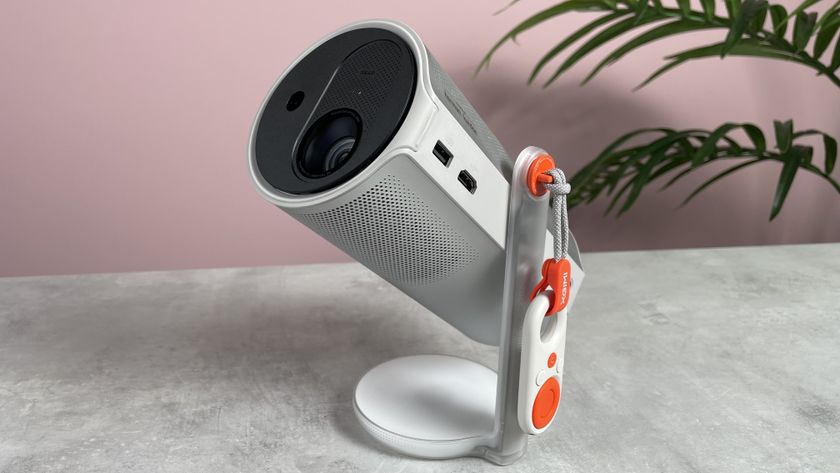 The XGIMI Mogo 4 is pictured on a tabletop, with the lens pointing up and left.