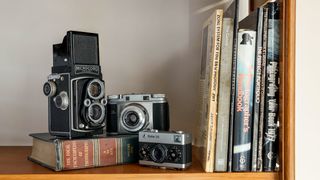 Bookshelf with old cameras and a selection of books on photography