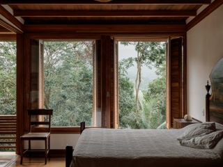 casa quinta by arquipelago, a wooden house on stilts above the rainforest canopy engulfed in greenery and open to nature