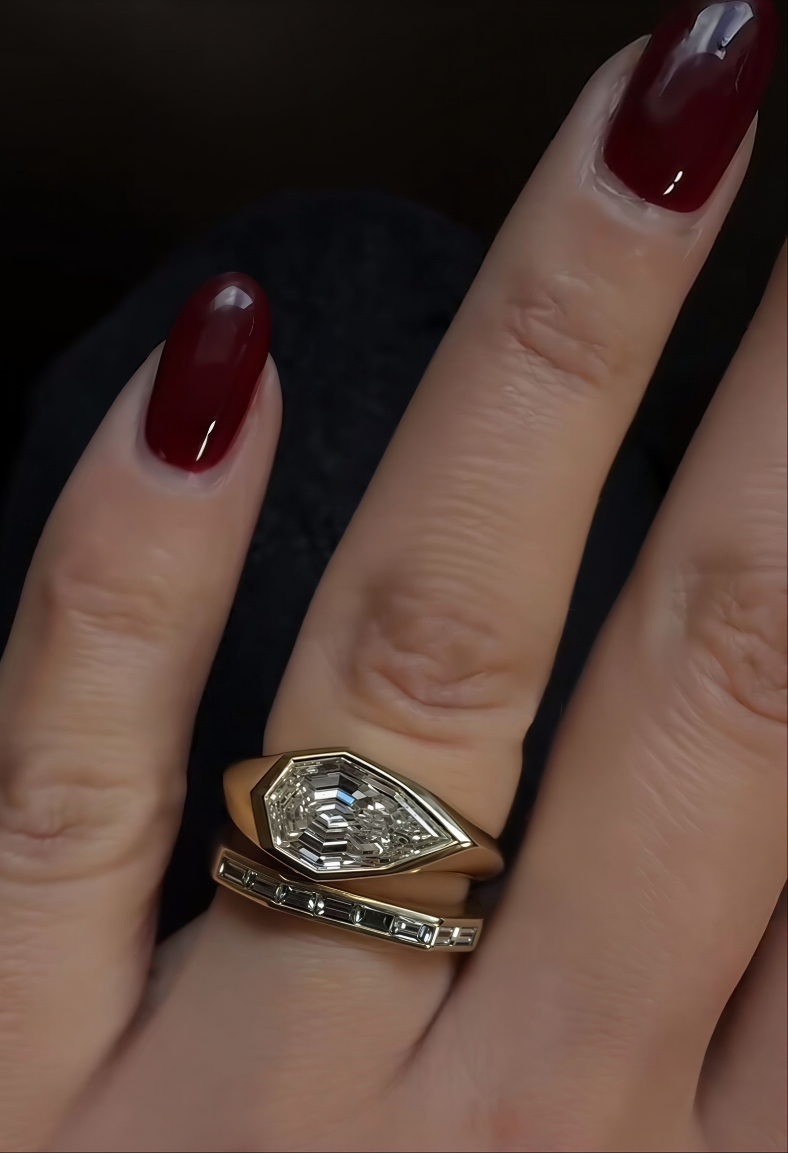 a close up of rachel boston's engagement ring and wedding band stack