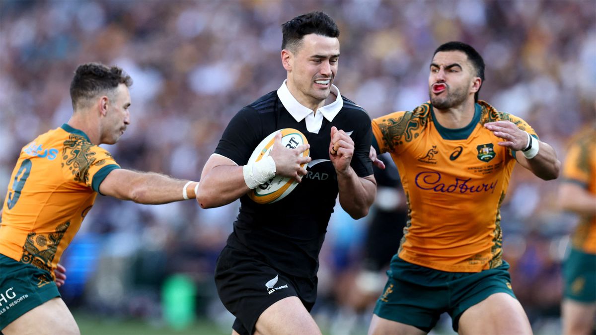 New Zealand&#039;s Will Jordan evades a tackle from Australia&#039;s Tom Wright and Nic White in their September 2024 Bledisloe Cup match in Sydney.