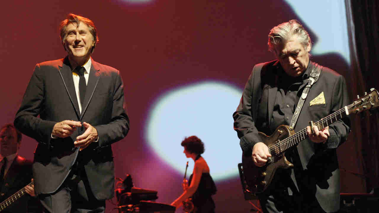 Chris Spedding performing onstage with Bryan Ferry in 2011