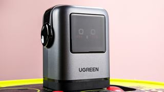 UGreen Uno Charger 100W plugged in with blushing emoji on display