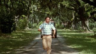 A young Forrest Gump runs away from a truck.