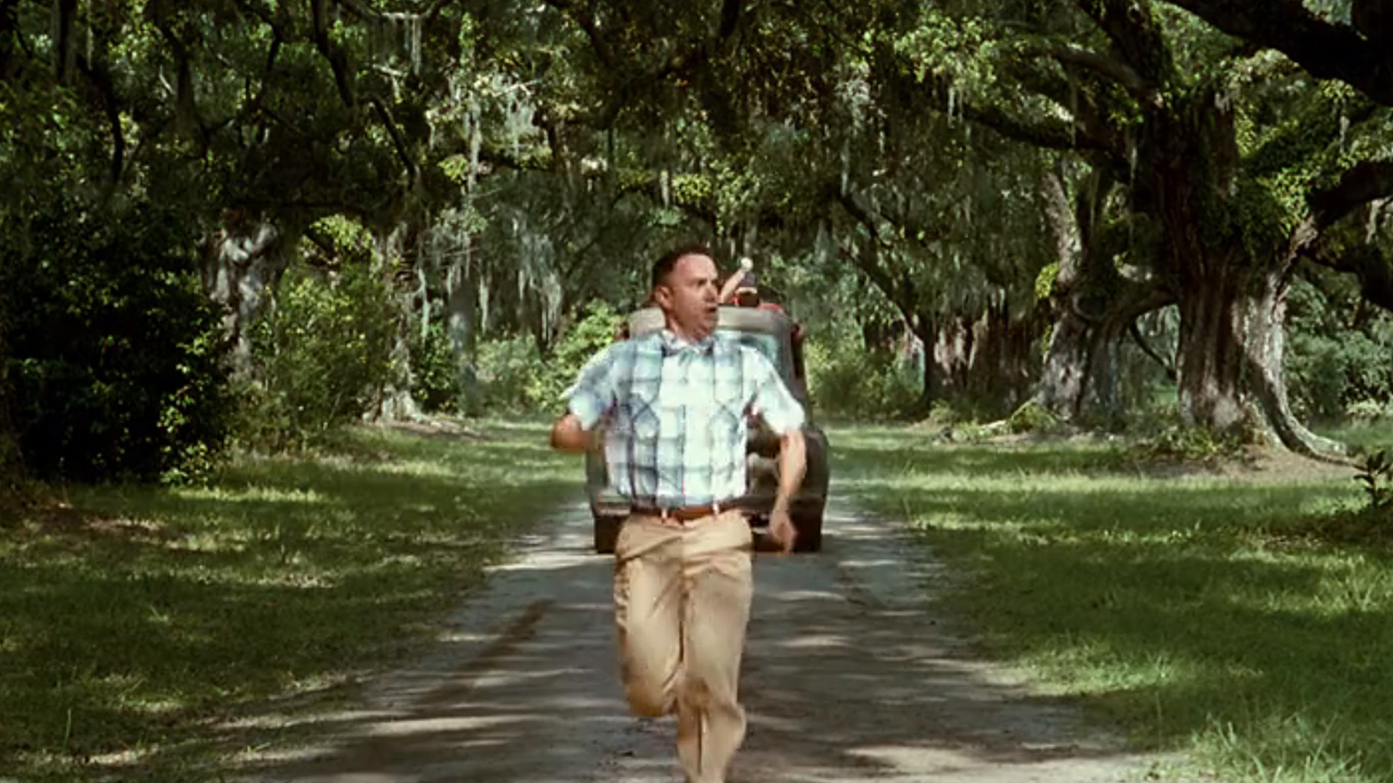 A young Forrest Gump runs away from a truck.