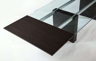 Table top with sections in wood and glass, metal bars visible underneath the glass holding the top