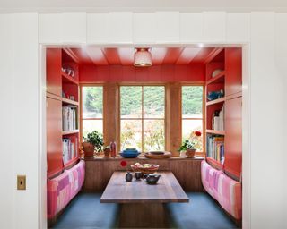 breakfast nook painted in bright red paint with large windows