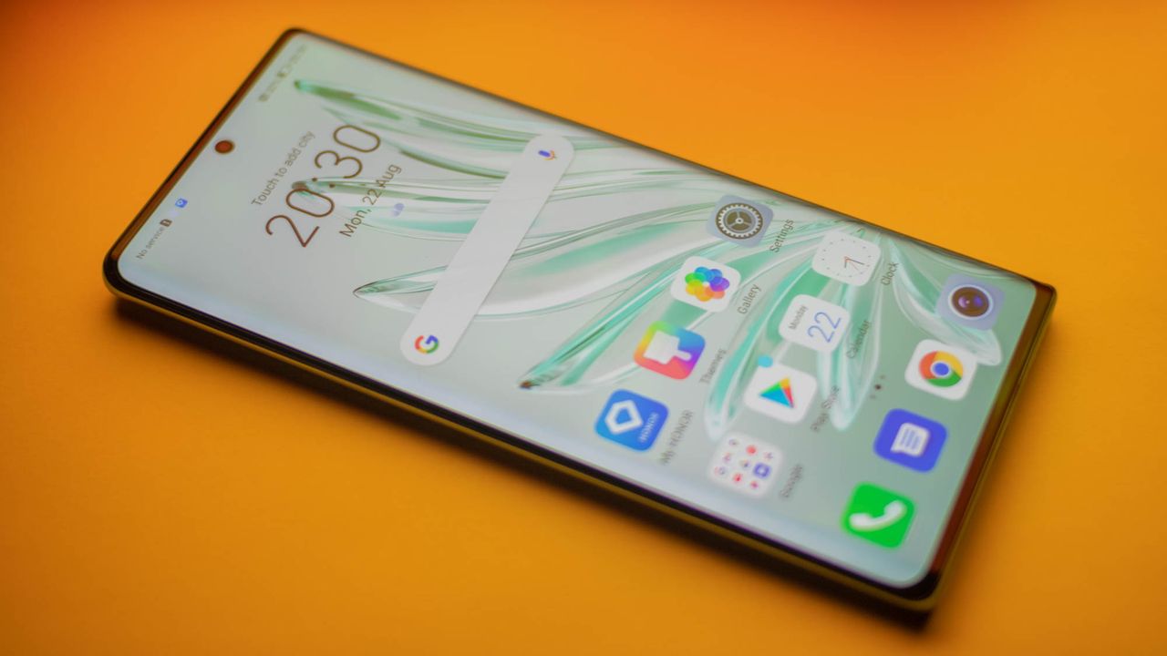 A photograph of the Honor 70 on an orange backdrop