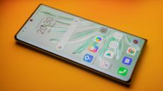 A photograph of the Honor 70 on an orange backdrop