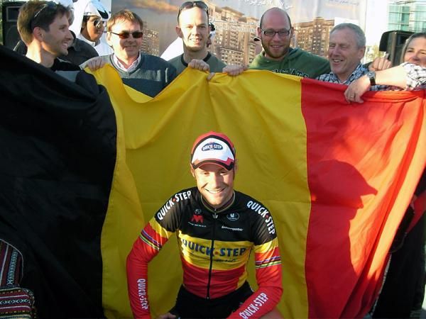 The Belgian national champion celebrates with the Belgian flag.