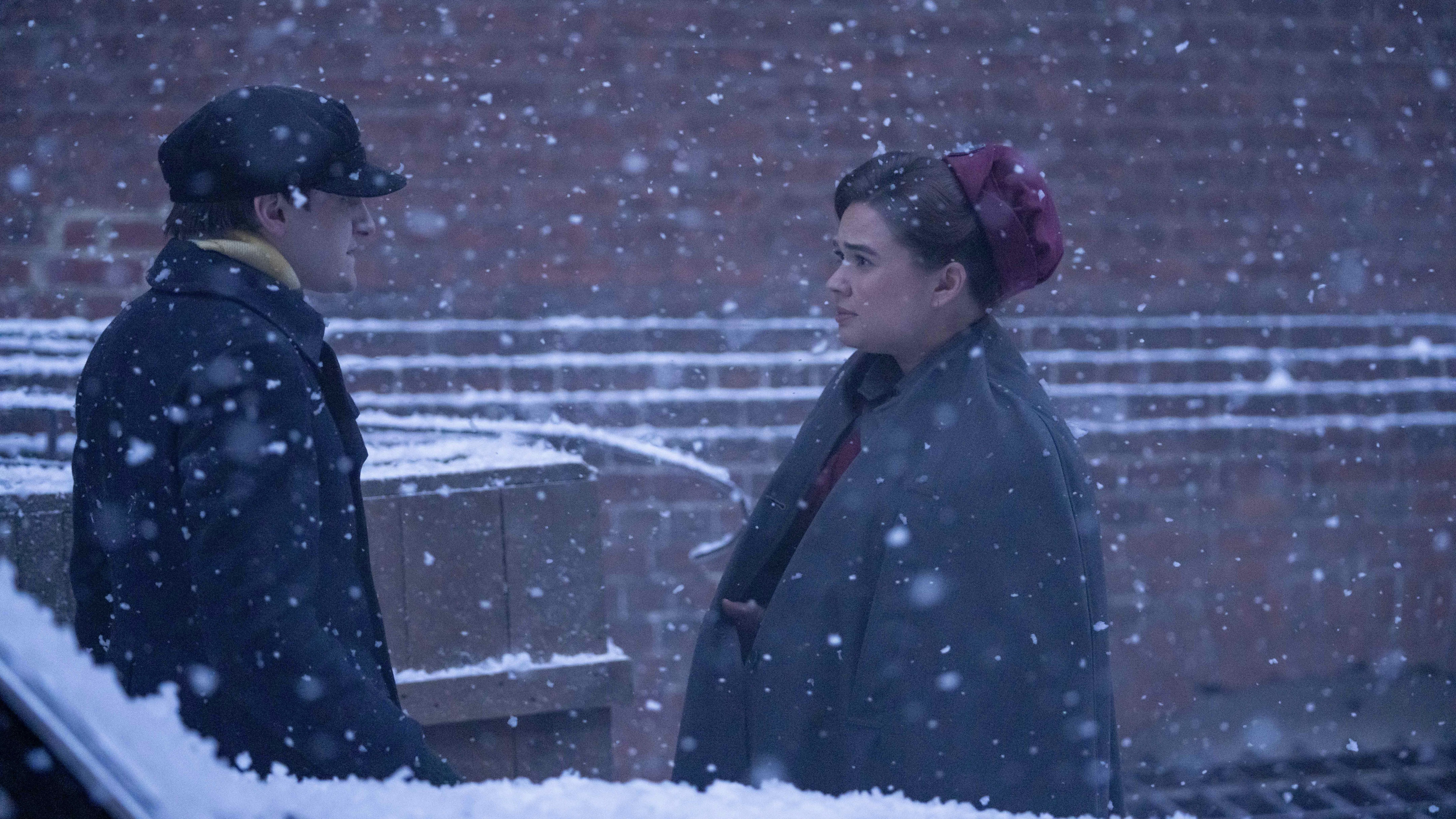 Max Macmillan in a hat and coat as Timothy and Megan Cusack in a nurse's uniform as Nancy stand in the snow in Call the Midwife.