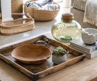 A wooden tray with decor collected on it