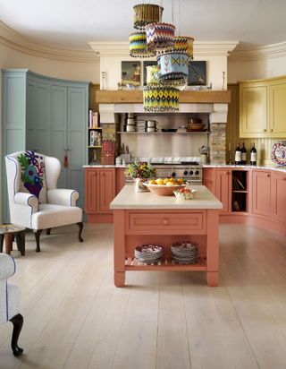a kitchen design by kit kemp using different colors of cabinetry