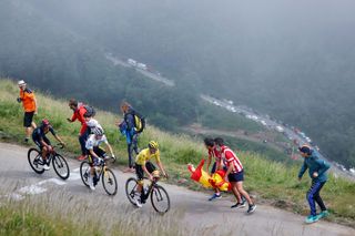 Team UAE Emirates Tadej Pogacar of Slovenia wearing the overall leaders yellow jersey rides ahead of Team Jumbo Vismas Jonas Vingegaard of Denmark wearing the best youngs white jersey and Team Ineos Grenadiers Richard Carapaz of Ecuador during the 17th stage of the 108th edition of the Tour de France cycling race 178 km between Muret and SaintLarySoulan on July 14 2021 Photo by Thomas SAMSON AFP Photo by THOMAS SAMSONAFP via Getty Images