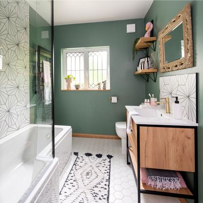 green bathroom with black and white tiles