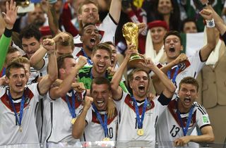 Philipp Lahm lifts the World Cup trophy alongside his Germany team-mates after victory in the 2014 final against Argentina.